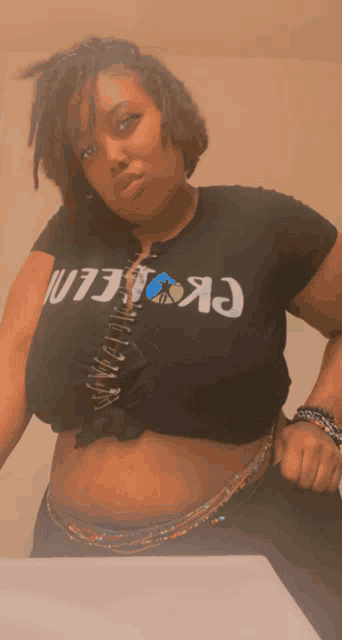 a woman wearing a black shirt that says ' ck ' on the front