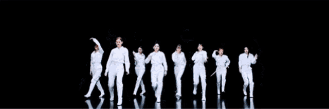a group of young women are dancing in a room .