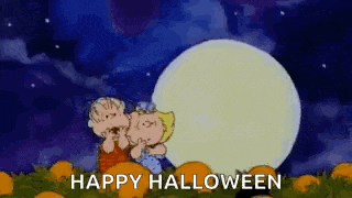 charlie brown and snoopy kissing in front of a full moon .