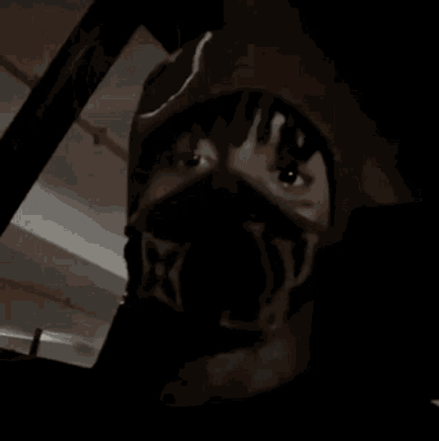 a man wearing a helmet with a monkey on it is looking out of a car window .