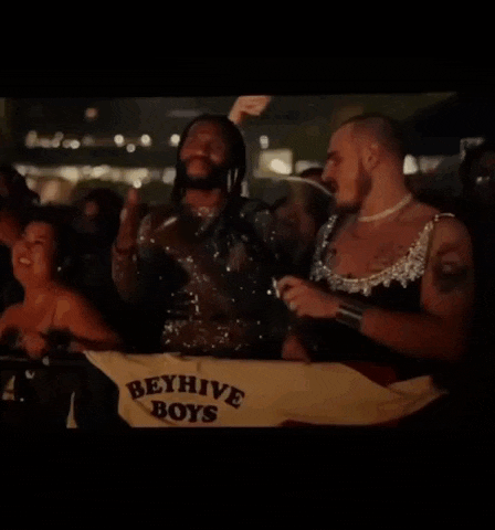 a group of people are dancing at a party and one of them is wearing a dress .