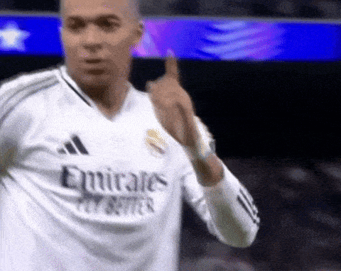 a soccer player wearing a white emirates fly better shirt