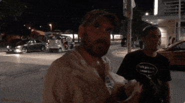 a man wearing a t-shirt that says " i 've got my sweat on " stands next to another man