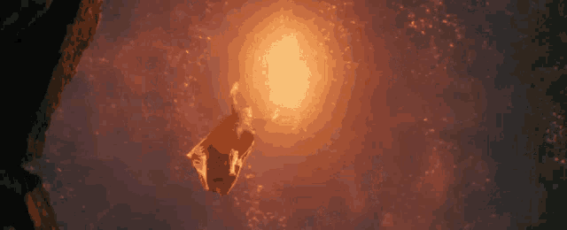 a person is flying through the air in front of a light