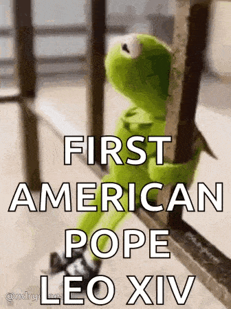 kermit the frog is sitting on a railing looking out a window and holding onto a metal pole .