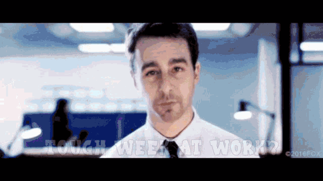 a man in a white shirt and tie says " tough week at work ? "