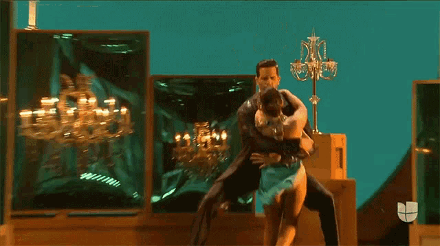 a man and a woman are dancing on a stage