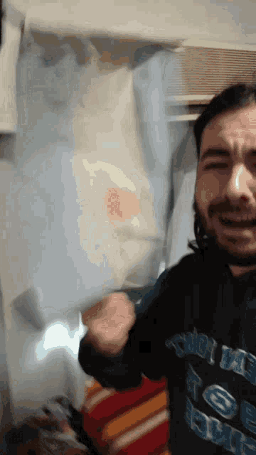 a man with a beard is wearing a shirt that says ' i love you '