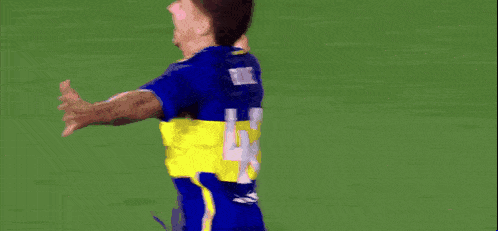 a blurry picture of a soccer player wearing a blue jersey with the number 9 on the back