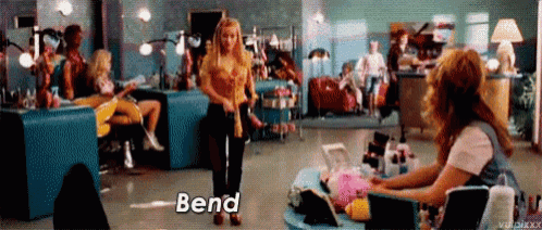 a woman is getting her nails done in a beauty salon and the word bend is on the screen .