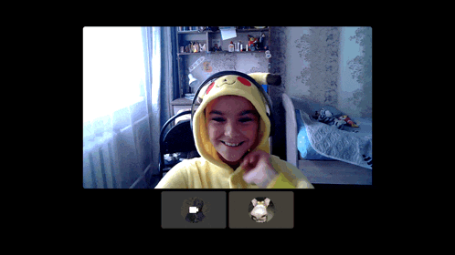 a girl wearing a pikachu hoodie is smiling in a video chat