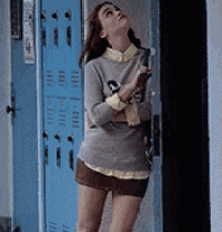 a woman leaning against a blue locker with the number 1 on it