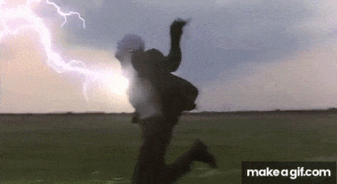 a person is jumping in the air while a lightning bolt is coming down the sky .