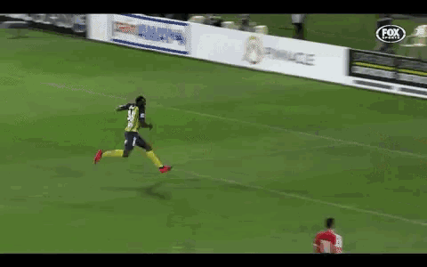 a soccer player with the number 23 on his jersey is running on the field