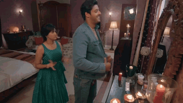 a man and woman are standing in front of a mirror