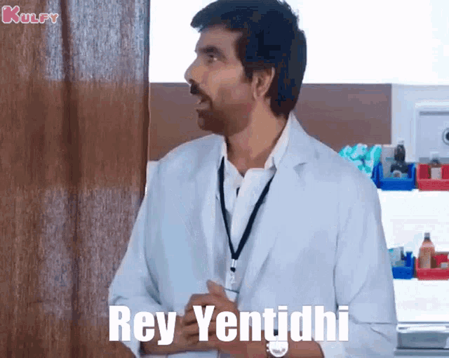 a man in a white lab coat is standing in front of a door and says rey yentidhi .