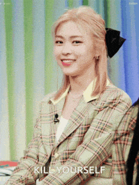 a woman in a plaid jacket with the words kill yourself written below her