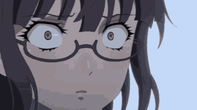 a close up of a girl 's face with glasses and a surprised look on her face