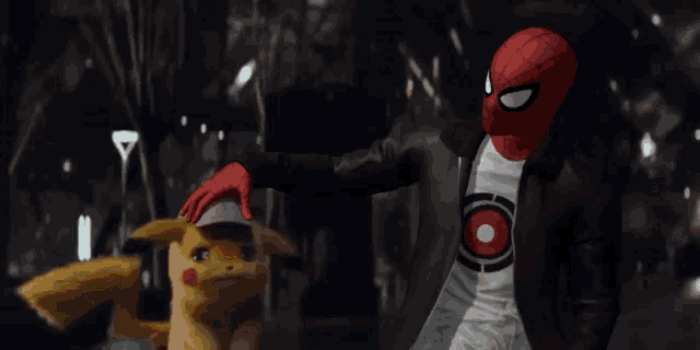 a man in a spiderman costume is standing next to a pikachu