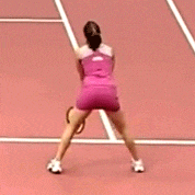 a woman in a pink dress stands on a track