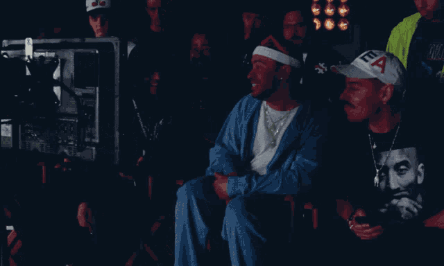 a man wearing a lea hat is sitting in front of a camera