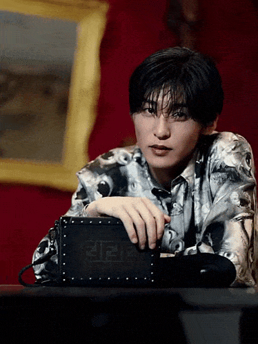 a man holding a black fendi purse in his hand