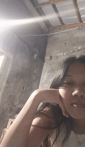 a woman taking a picture of herself with her hand on her face