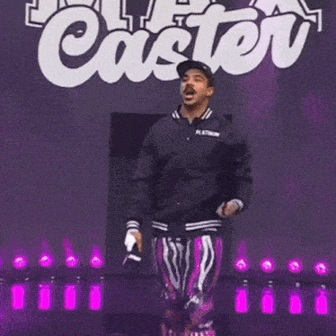 a man holding a certificate in front of a caster sign