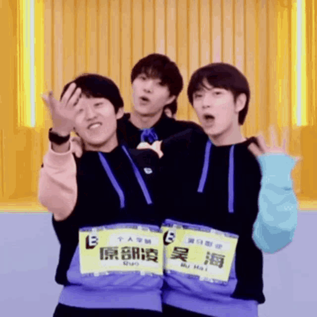 three young men are posing for a picture and one of them has a name tag that says b