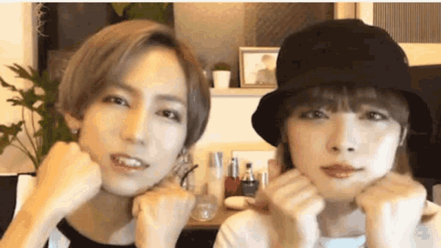 a man and a woman are making funny faces with their hands