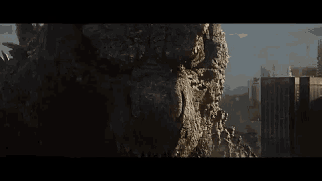 a large rock is flying through the air in front of a city skyline .