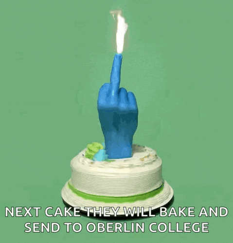a blue hand holding a lit candle on top of a cake