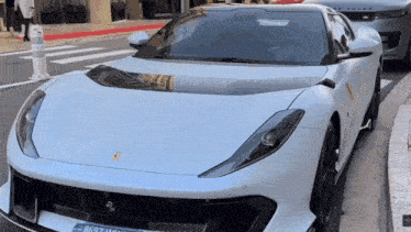 a white sports car with a license plate that says 8697