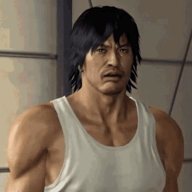 a man with black hair is wearing a white tank top and looking at the camera .