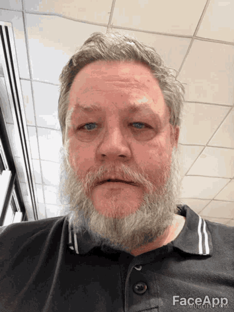 a man with a beard is wearing a black shirt that says face app