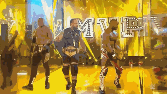 a group of wrestlers are standing in front of a sign that says mvp