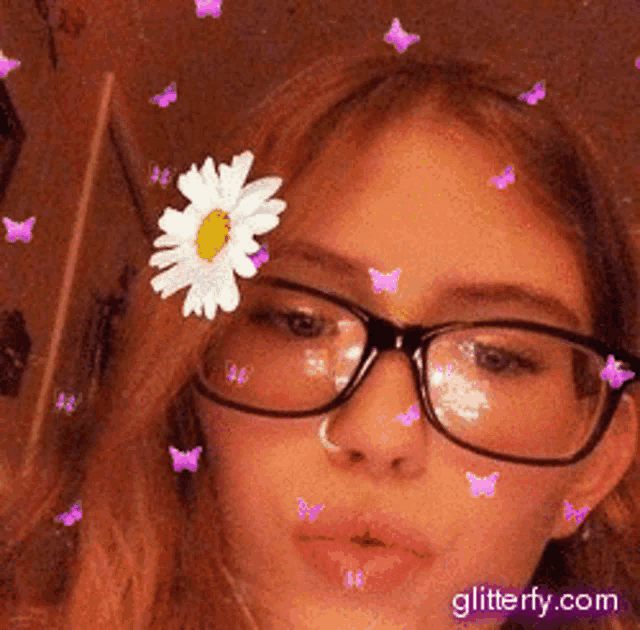 a girl wearing glasses has a flower in her hair and butterflies are flying around her