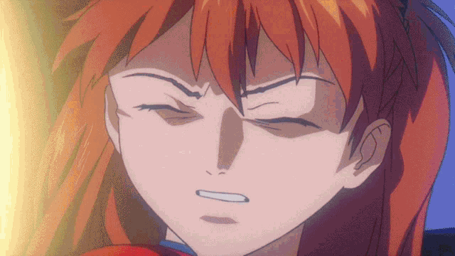 a close up of a girl with red hair making a face