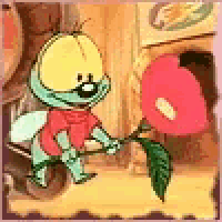 a cartoon worm is holding a flower in his hand .