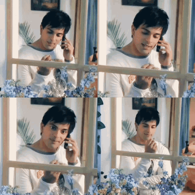 a man talking on a cell phone while looking out a window