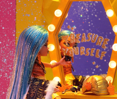 a doll with blue hair looks at her reflection in a mirror that says treasure yourself