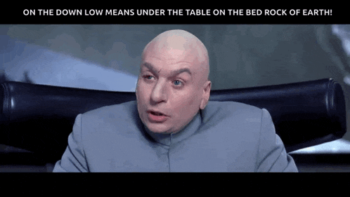 a bald man is sitting in a chair with the words on the down low means under the table on the bed rock of earth below him