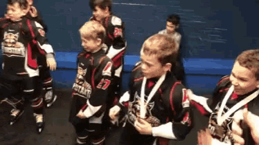 a group of young boys are wearing jerseys that say jets