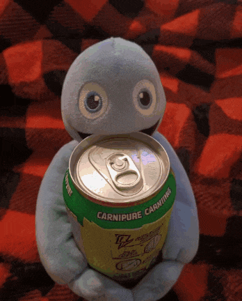a stuffed animal is holding a can that says carnipure carnitine