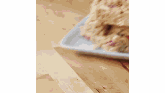 a piece of cake on a white plate on a wooden table