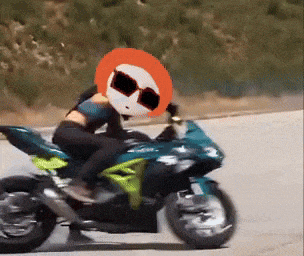 a person riding a motorcycle with an orange head