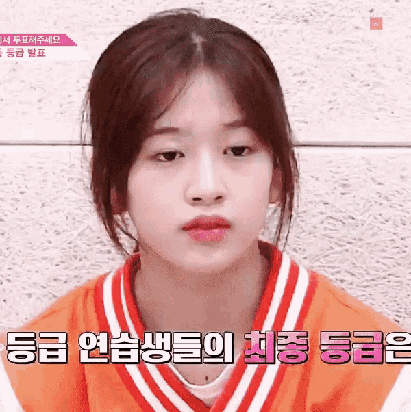 a girl wearing a red and white striped sweater is looking at the camera