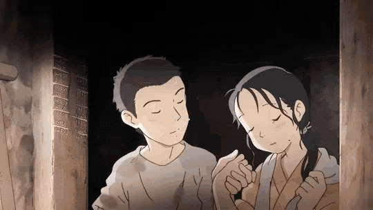 a boy and a girl are holding hands and looking at each other