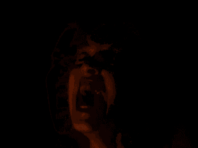 a close up of a woman 's face with a red background