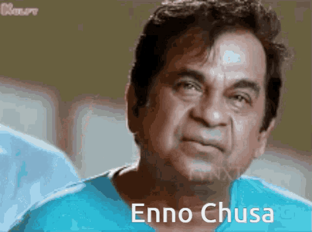 a man wearing a blue shirt with the words enno chusa written on it